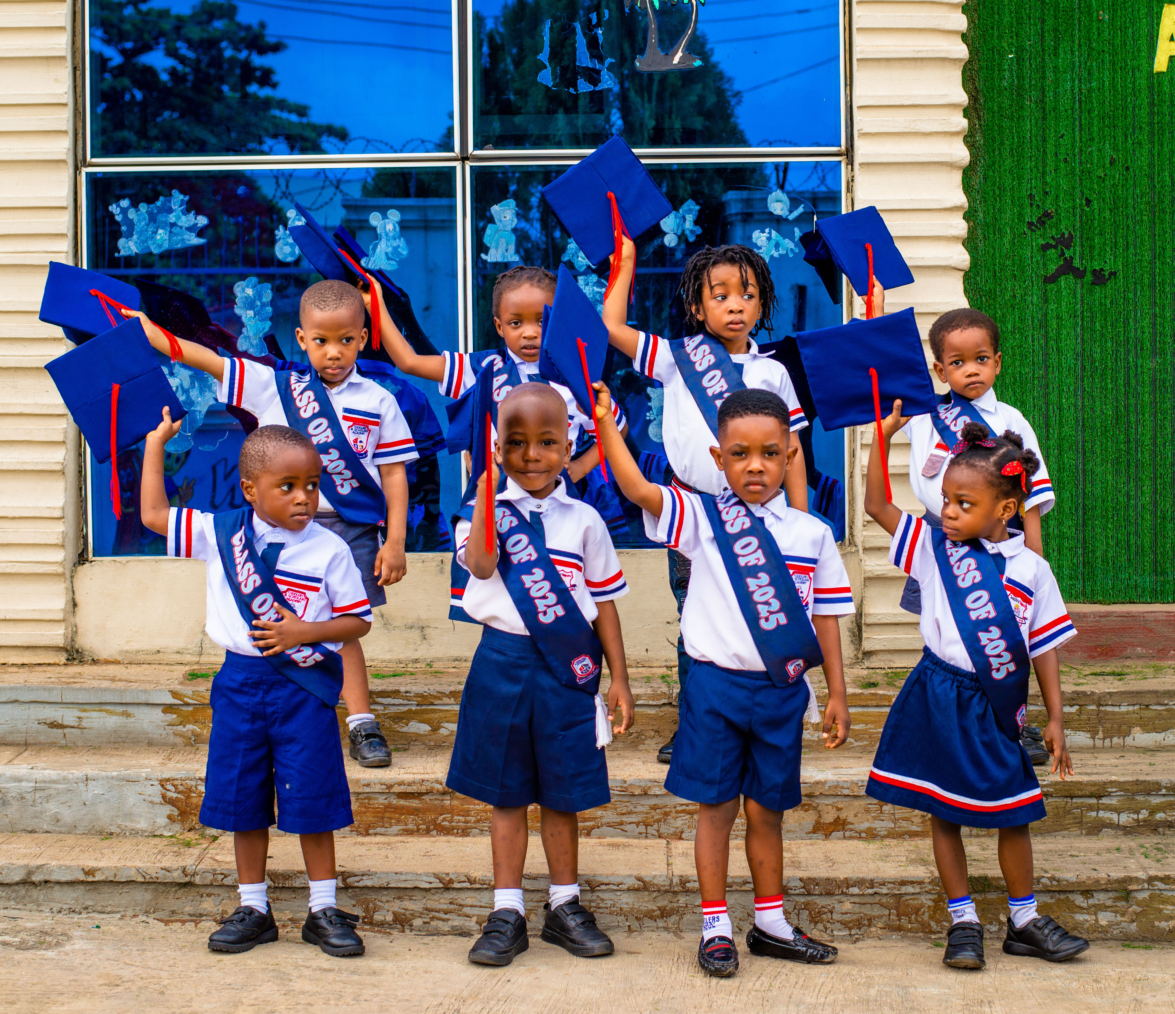 Graduating class with caps in hand
