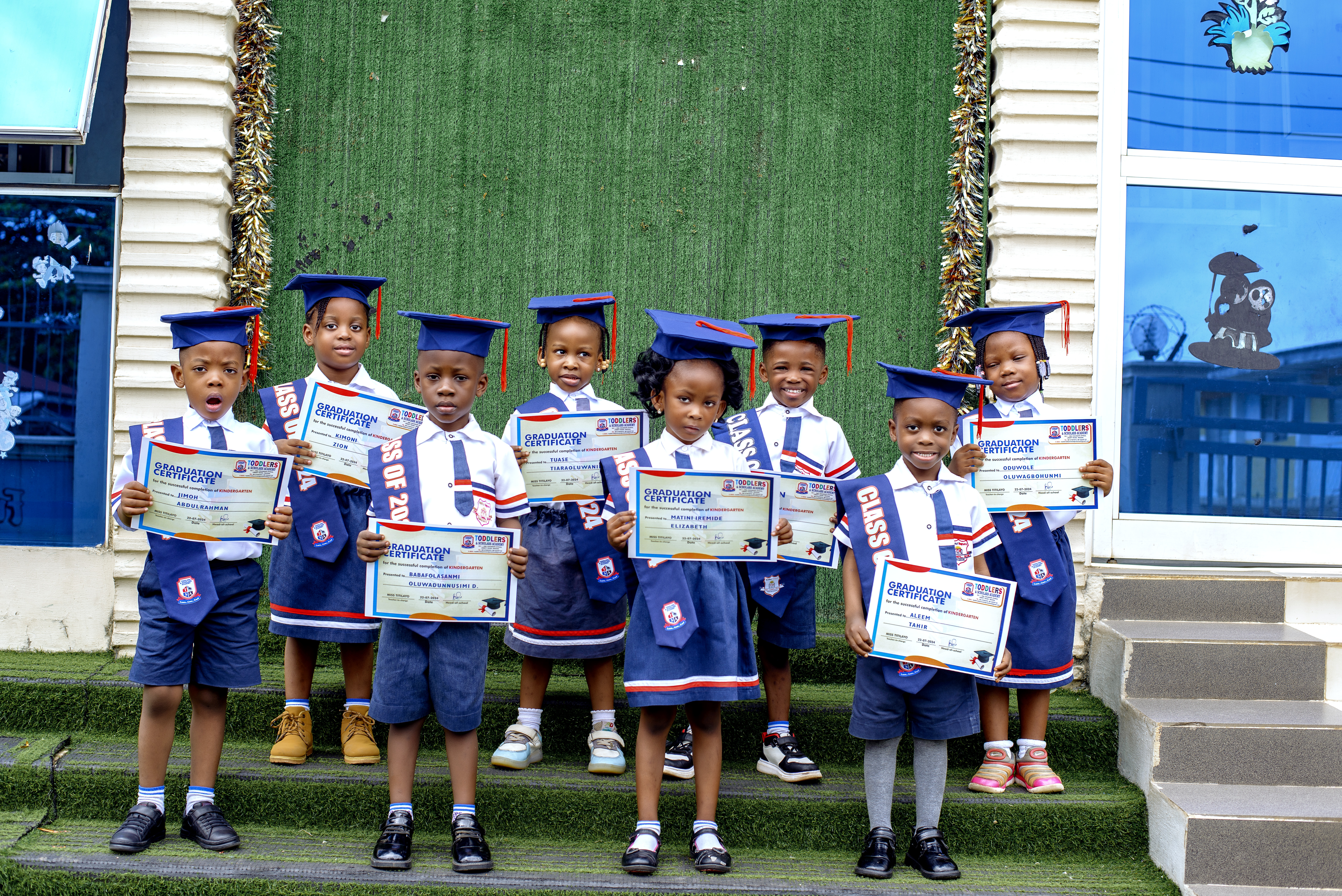Graduates holding their certificates